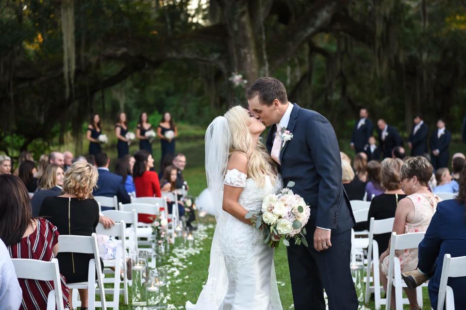 Couple kissing in the aisle at their wedding