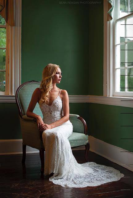 Bride sitting on a chair looking out the window